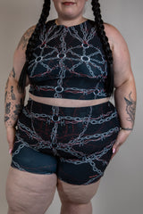 Model wearing the Purgatory Crop Top with chain design, perfect for rave outfits and festival fashion.