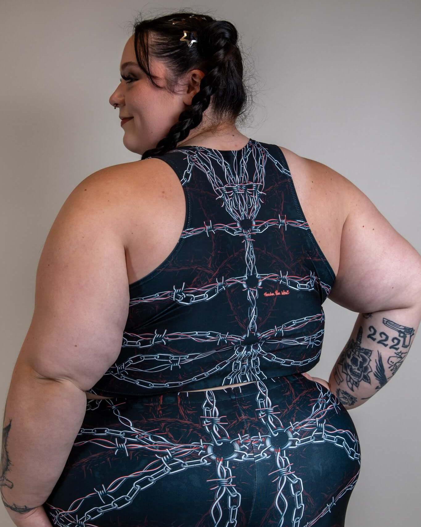 Back view of a model wearing the Purgatory Crop Top with chain detailing, showcasing a unique design for rave outfits.