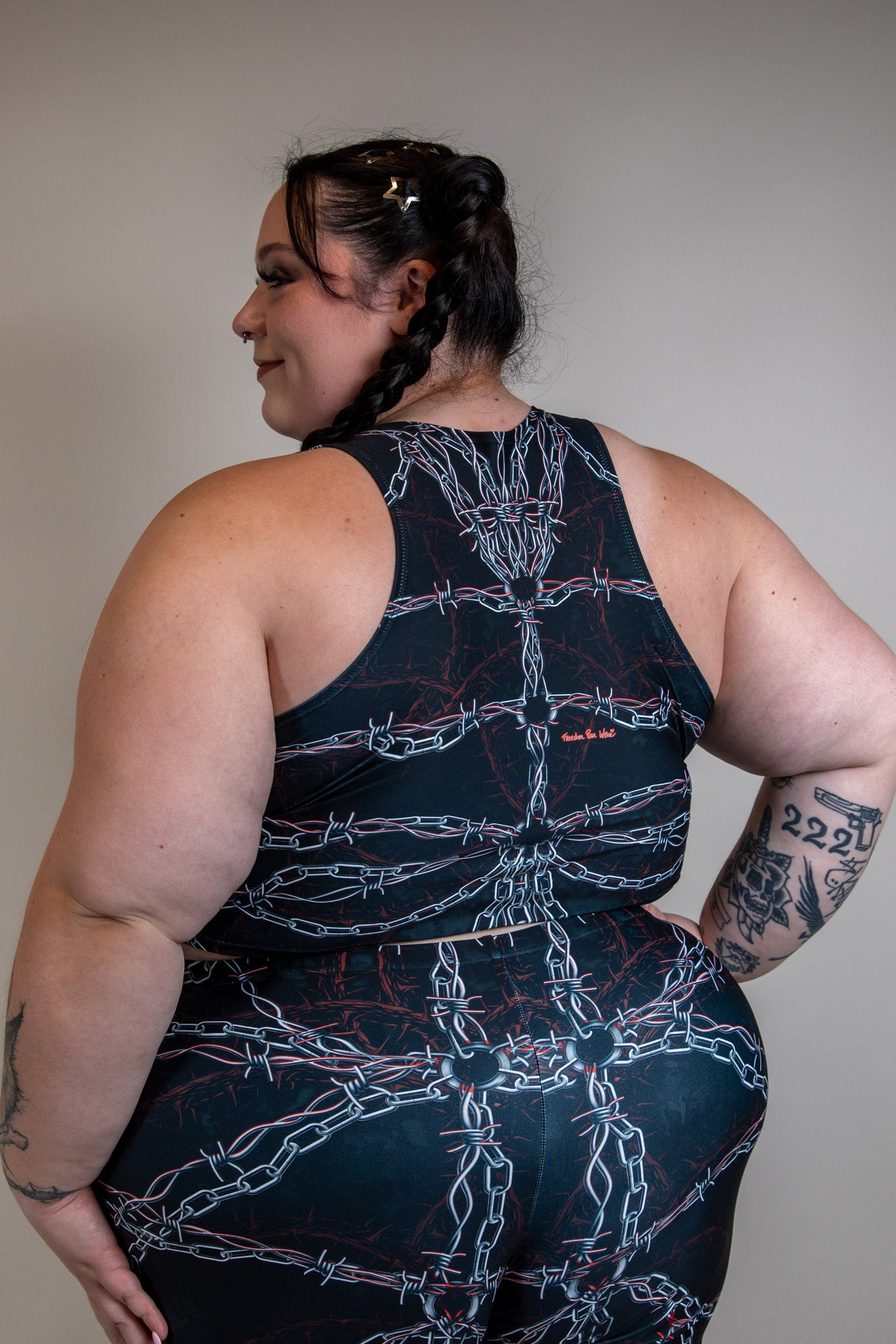 Back view of Purgatory Crop Top with chain and barbed wire pattern, sleeveless high-neck design, ideal for edgy festival outfits.