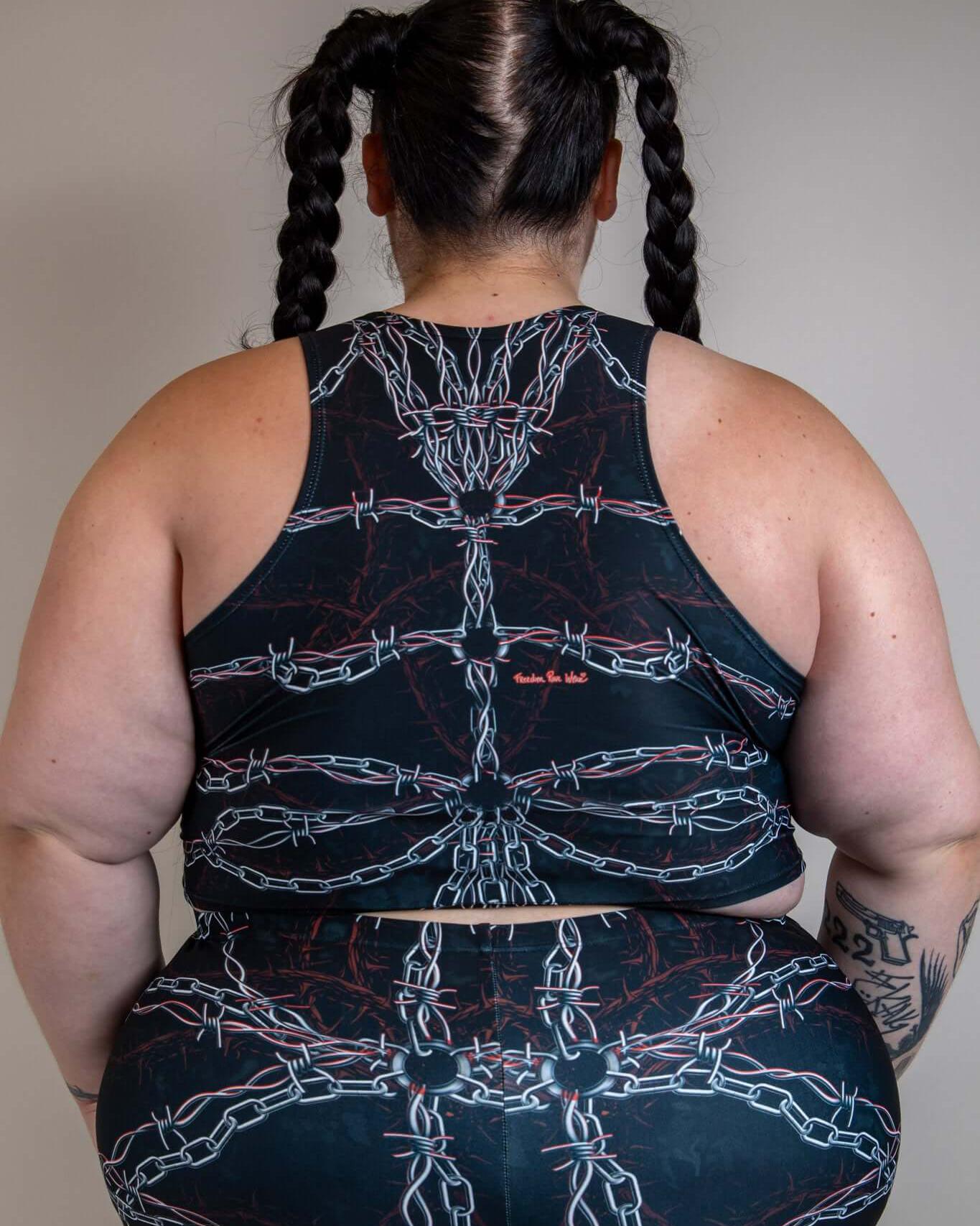 Back view of a person wearing the Purgatory Crop Top featuring chain detailing, styled for a festival look.