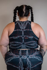 Back view of a person wearing the Purgatory Crop Top featuring chain detailing, styled for a festival look.