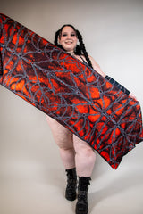 Model showcasing Purgatory festival scarf with vibrant red and black design, perfect for rave outfits and festival fashion.