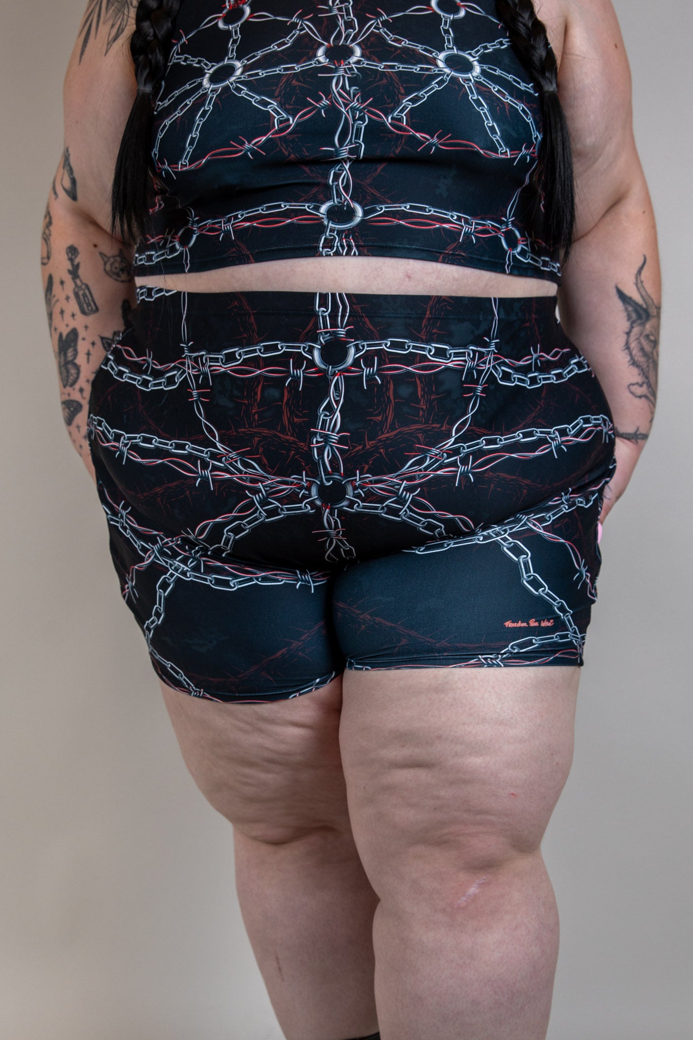 Front view of Purgatory High Waist Shorts with dark chain and barbed wire pattern, high-waisted fit, perfect for festival wear.