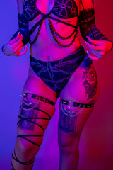 Model wearing the Purgatory High Waisted Thong with chain details and bold accessories, styled for rave outfits.