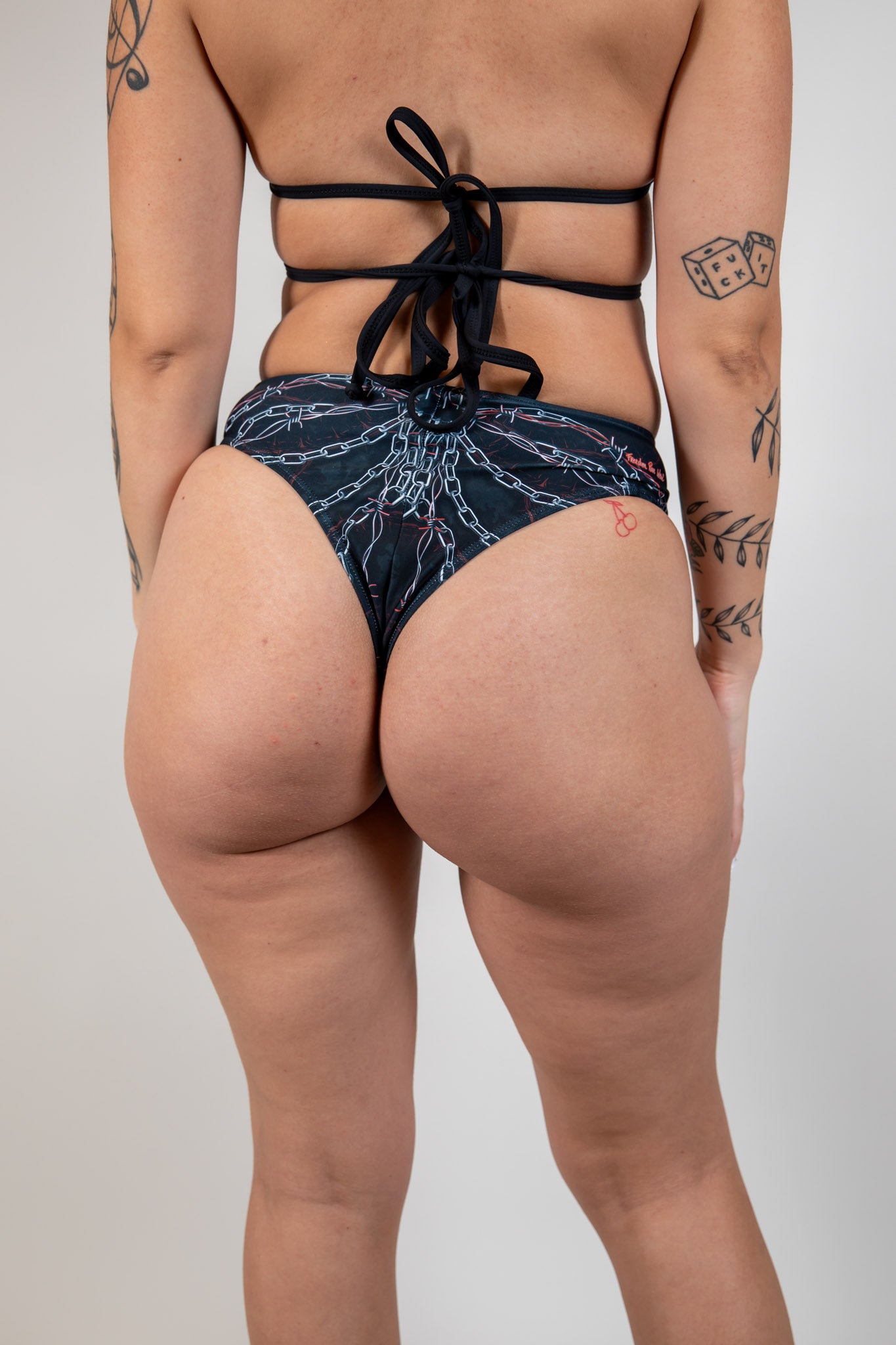 Back view of Purgatory High Waisted Thong with chain and barbed wire pattern, high-waisted cheeky fit, perfect for festival wear.