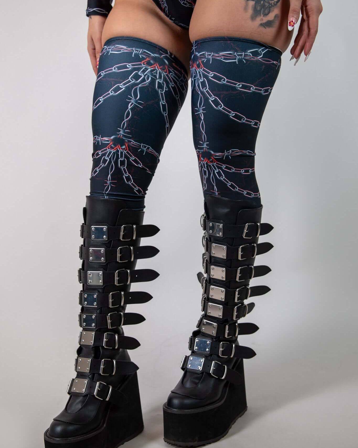 Sleek Purgatory Leg Sleeves with chain graphic, perfect for enhancing rave outfits and style on the dance floor.