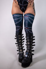 Close-up front view of Purgatory Leg Sleeves with chain and barbed wire pattern, high-thigh fit, perfect for festival wear.