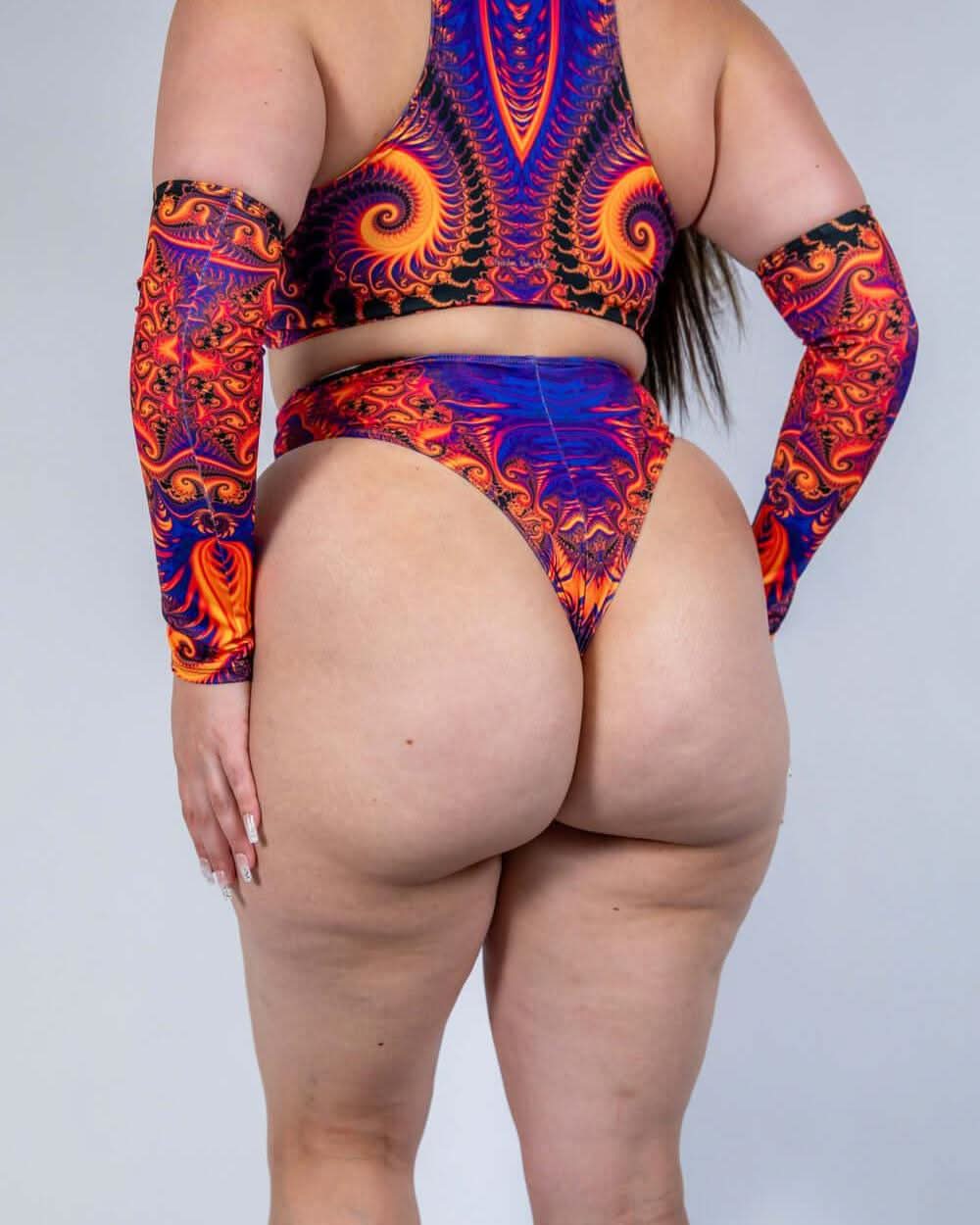 Woman modeling Radiance High Waisted Thong and colorful arm sleeves, perfect for rave outfits.