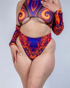 Model wearing a vibrant orange, violet, and pink high waisted thong with matching top, perfect for rave outfits.