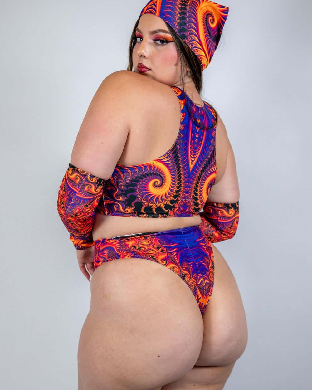 Model showcasing Radiance Teaser Top in vibrant swirl design, perfect for rave outfits and confident self-expression.