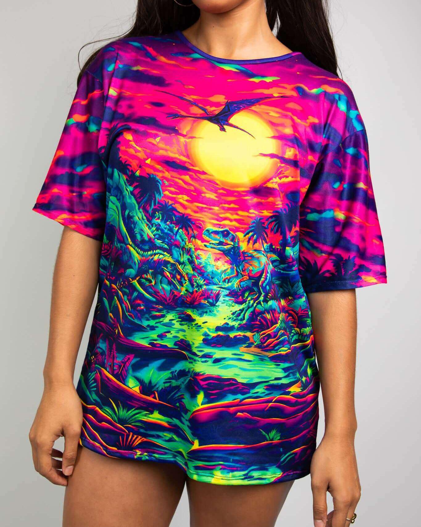 Raptor Oversized Softee rave tee featuring a vibrant dinosaur world print and sunset scene, perfect for parties.