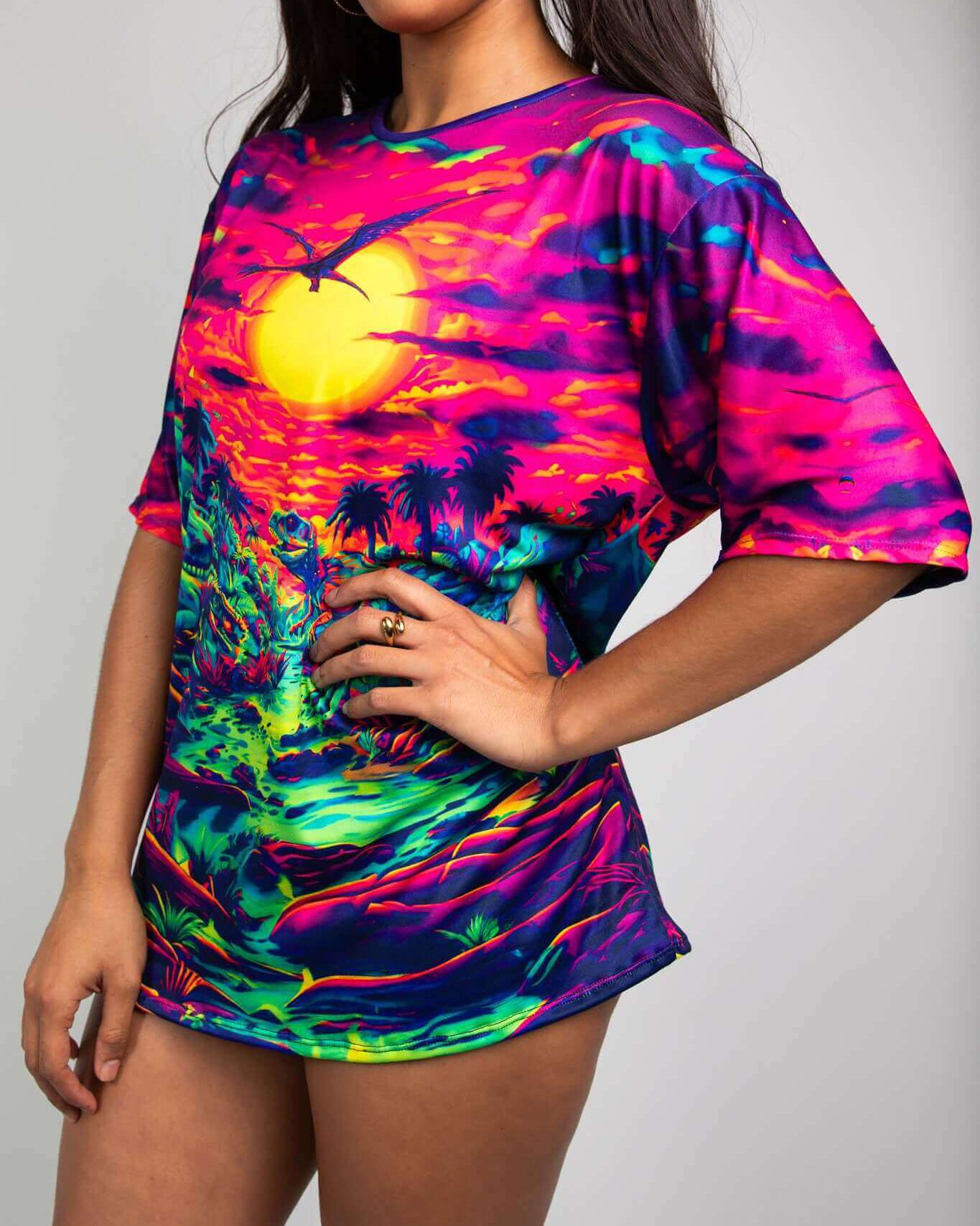 Model wearing Raptor Oversized Softee tee with vibrant dinosaur print, perfect for rave outfits and parties.