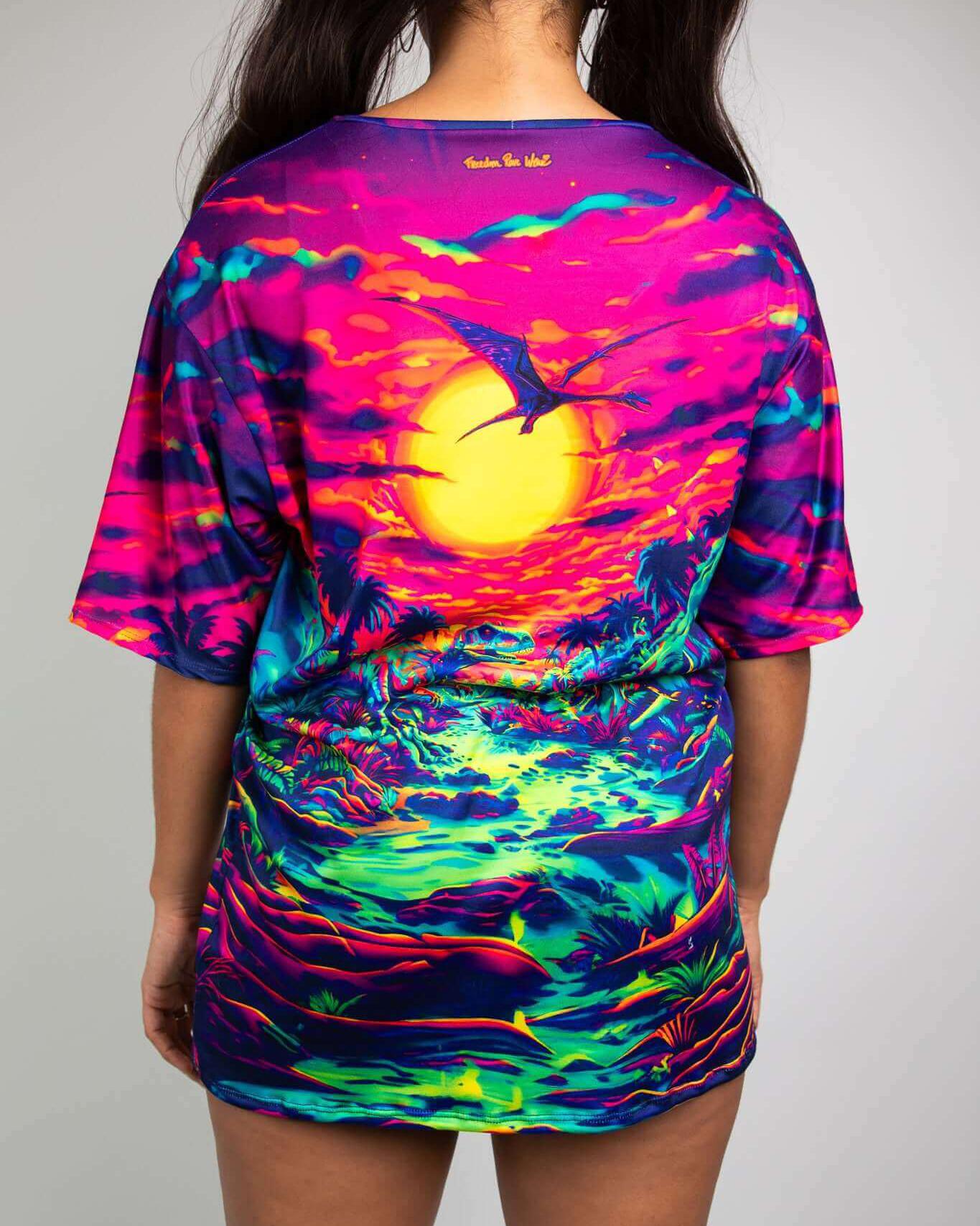 Raptor Oversized Softee in vibrant dinosaur print, showcasing a colorful sunset landscape, perfect for rave outfits.