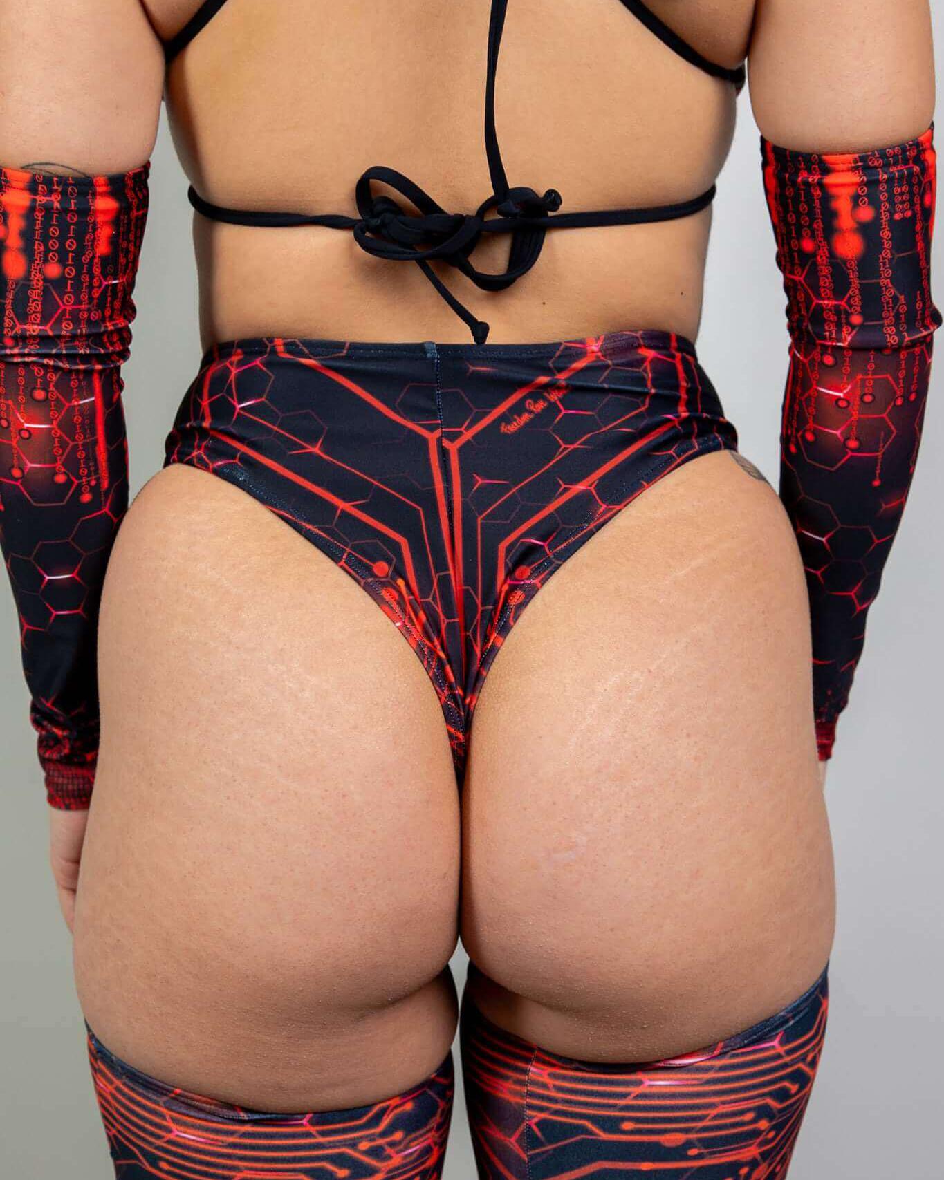 Model showcasing a high waist thong with a red circuit design, paired with matching long sleeves for rave outfits.