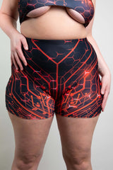 Freedom Rave Wear red and black circuit-pattern high-waisted shorts featured on a model posing against a neutral background