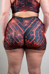 Rear view of Freedom Rave Wear high-waisted shorts in red and black circuit design, emphasizing fit and style on a neutral backdrop