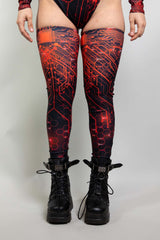 Freedom Rave Wear's red circuit-patterned leg sleeves with black boots: the ultimate fusion of edge and rave-ready style