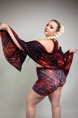 Back view of model in Freedom Rave Wear circuit-pattern shorts and draped pashmina, accentuating style with braids and a dynamic pose