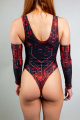 Rear view of a woman wearing a Freedom Rave Wear bodysuit with a low back and circuit design, complemented by red and black arm sleeves