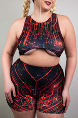 Close-up of model in Freedom Rave Wear circuit-pattern top and shorts, featuring detailed electronic design, styled with classic braids
