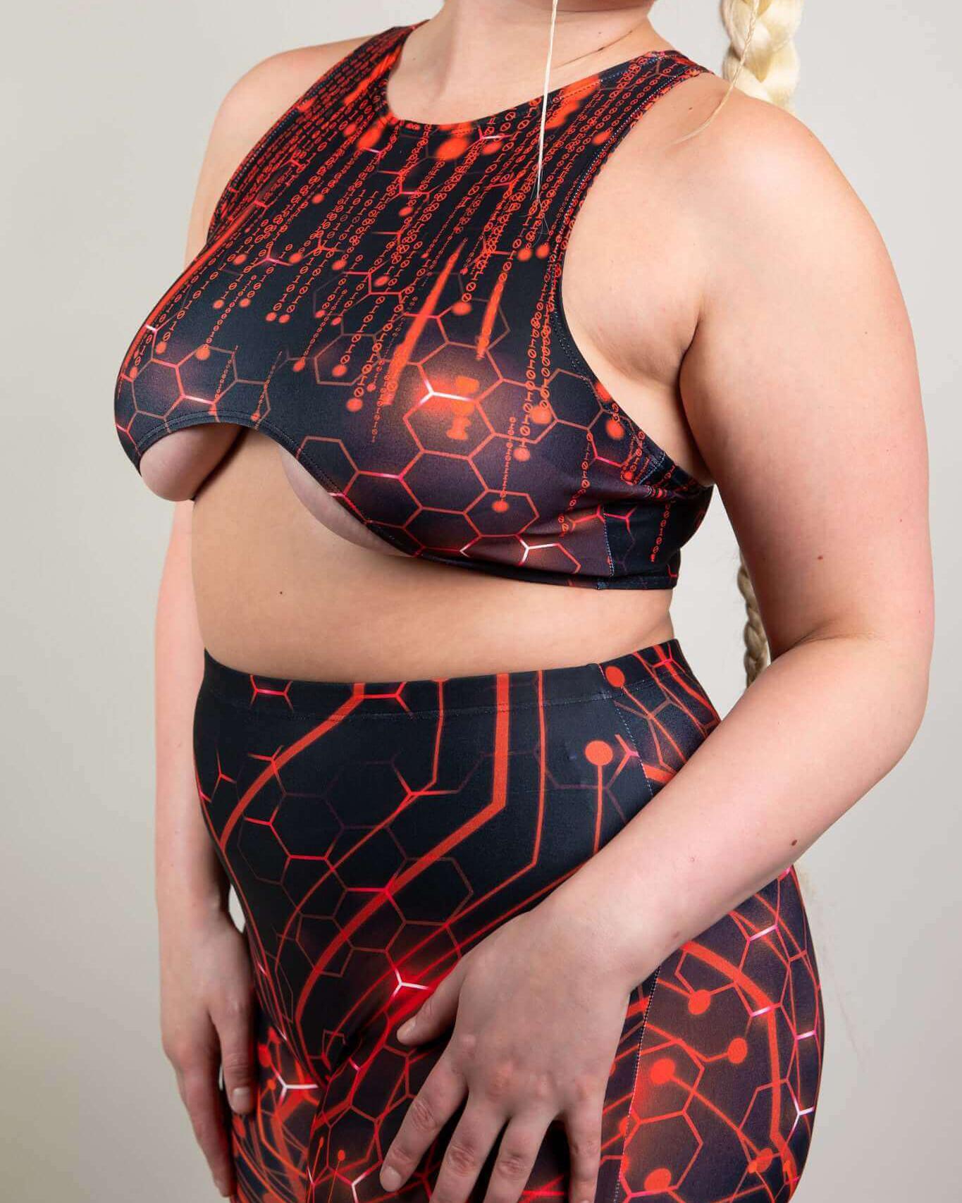 Model showcasing the Red Singularity Teaser Top, a stylish rave outfit with underboob exposure and a unique hexagonal print.