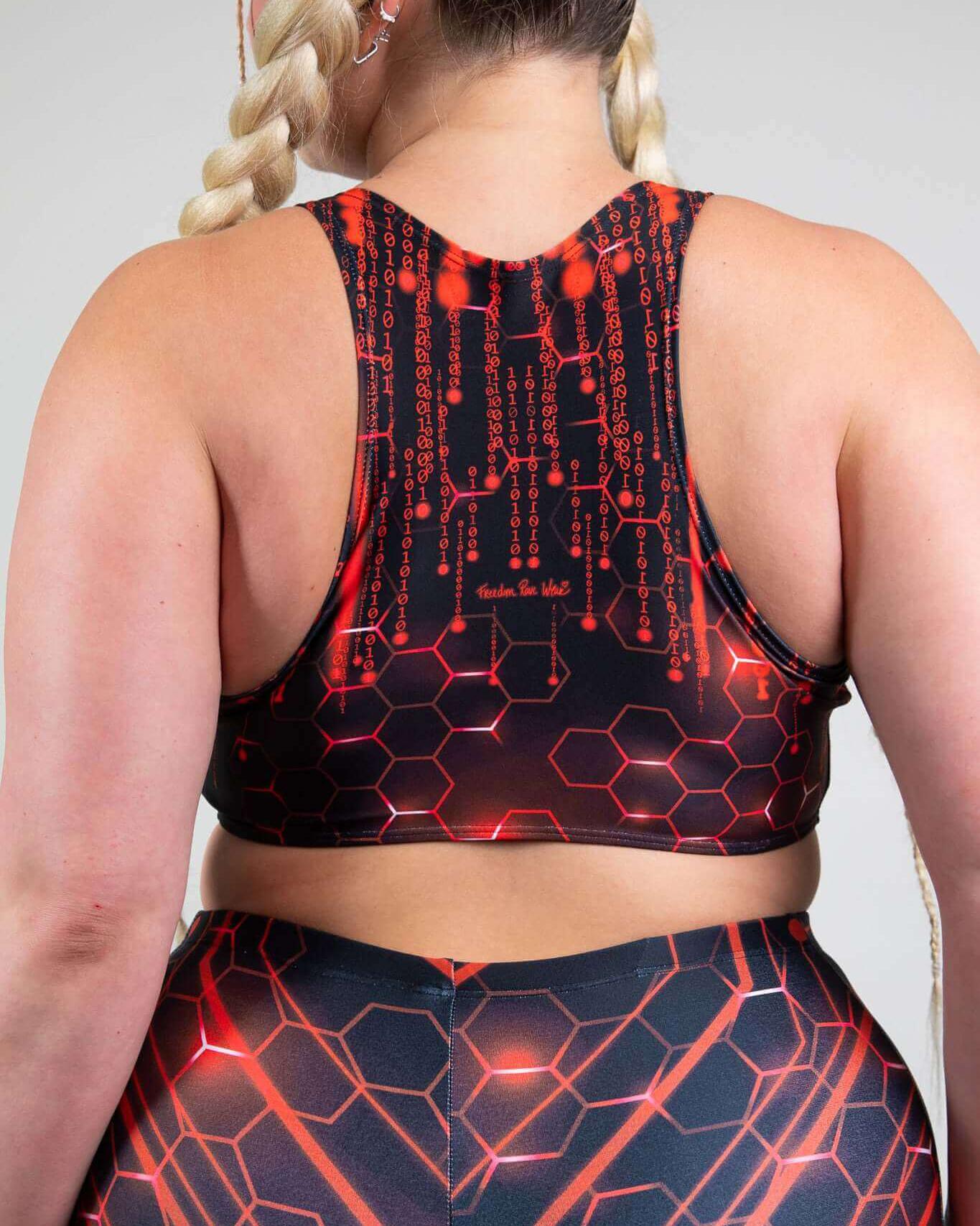 Woman wearing a Red Singularity Teaser Top with racerback design, showcasing edgy rave outfits style.