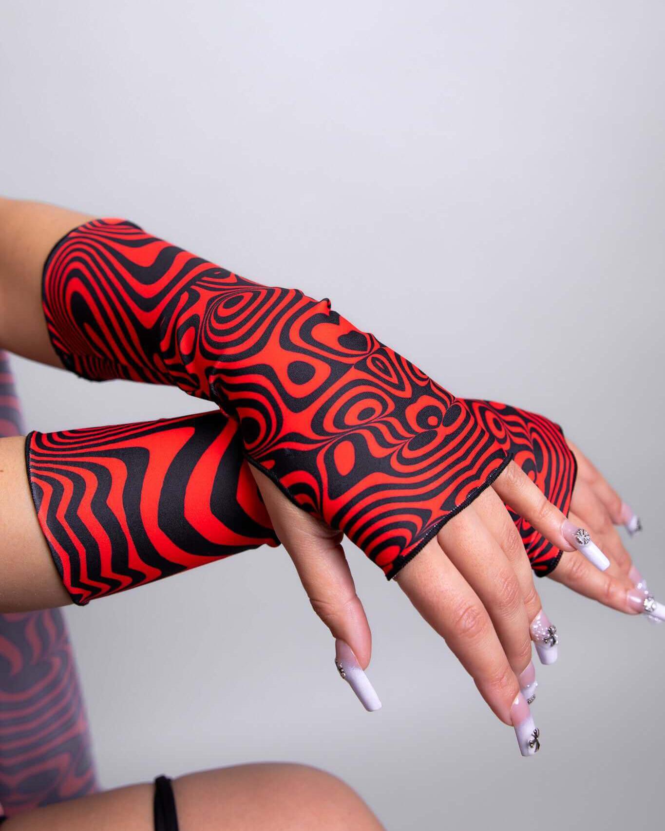 Red Void Gloves featuring a swirl pattern, perfect for stylish rave outfits, handmade in San Diego.