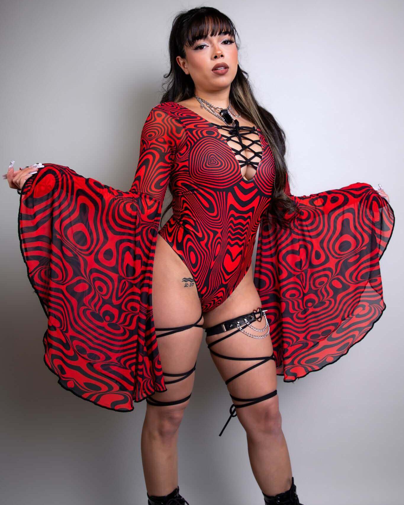 Woman wearing a Red Void Goddess Bodysuit with dramatic sleeves and lace-up detailing, perfect for rave outfits.