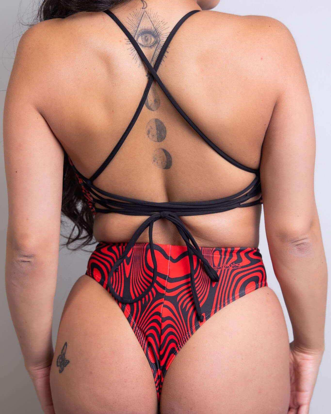 Stylish red and black high-waisted bikini with crisscross straps, showcasing a unique pattern and back view.