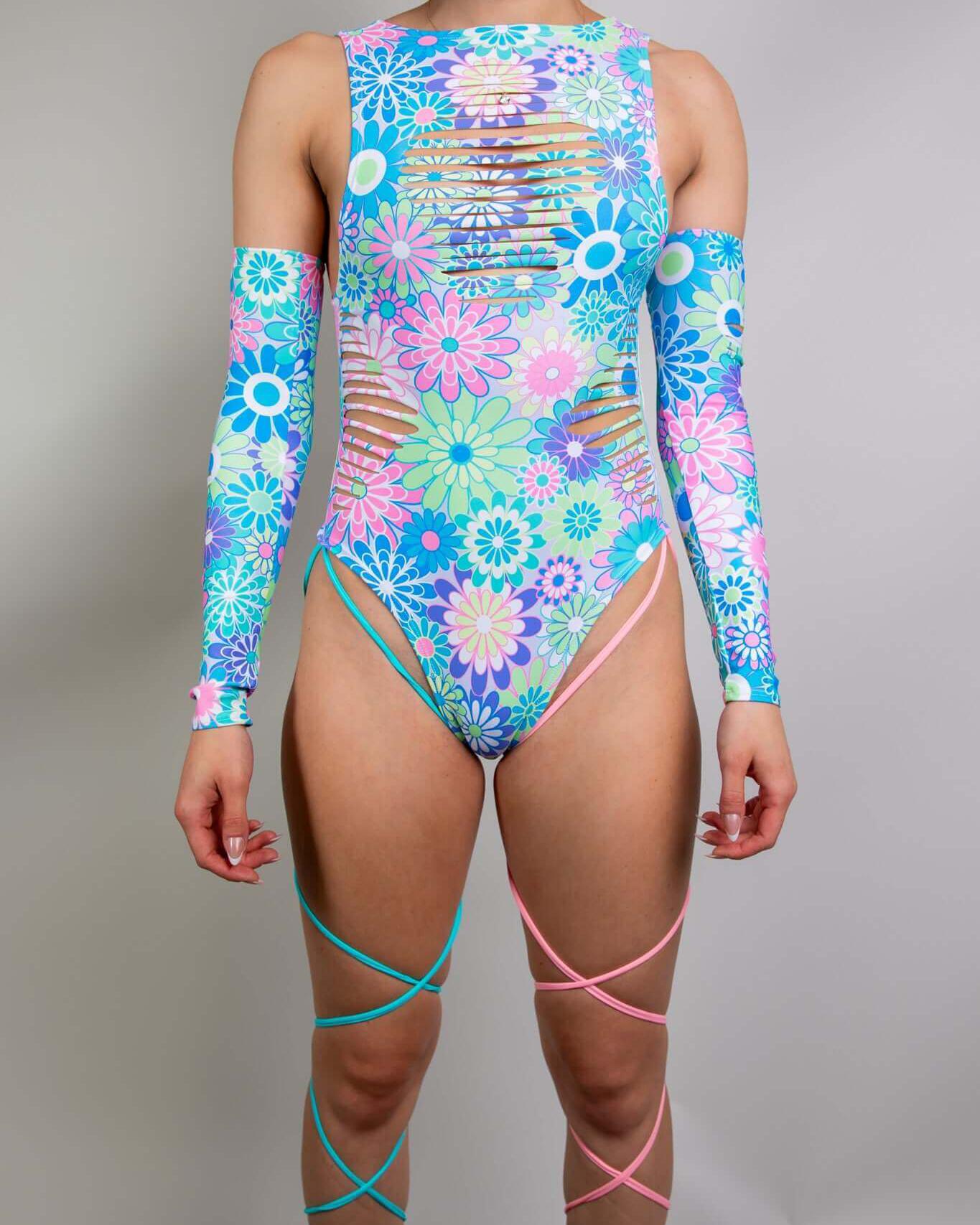 Retro Bloom bodysuit with floral print, side slits, and leg straps, perfect for rave outfits and dance floors.