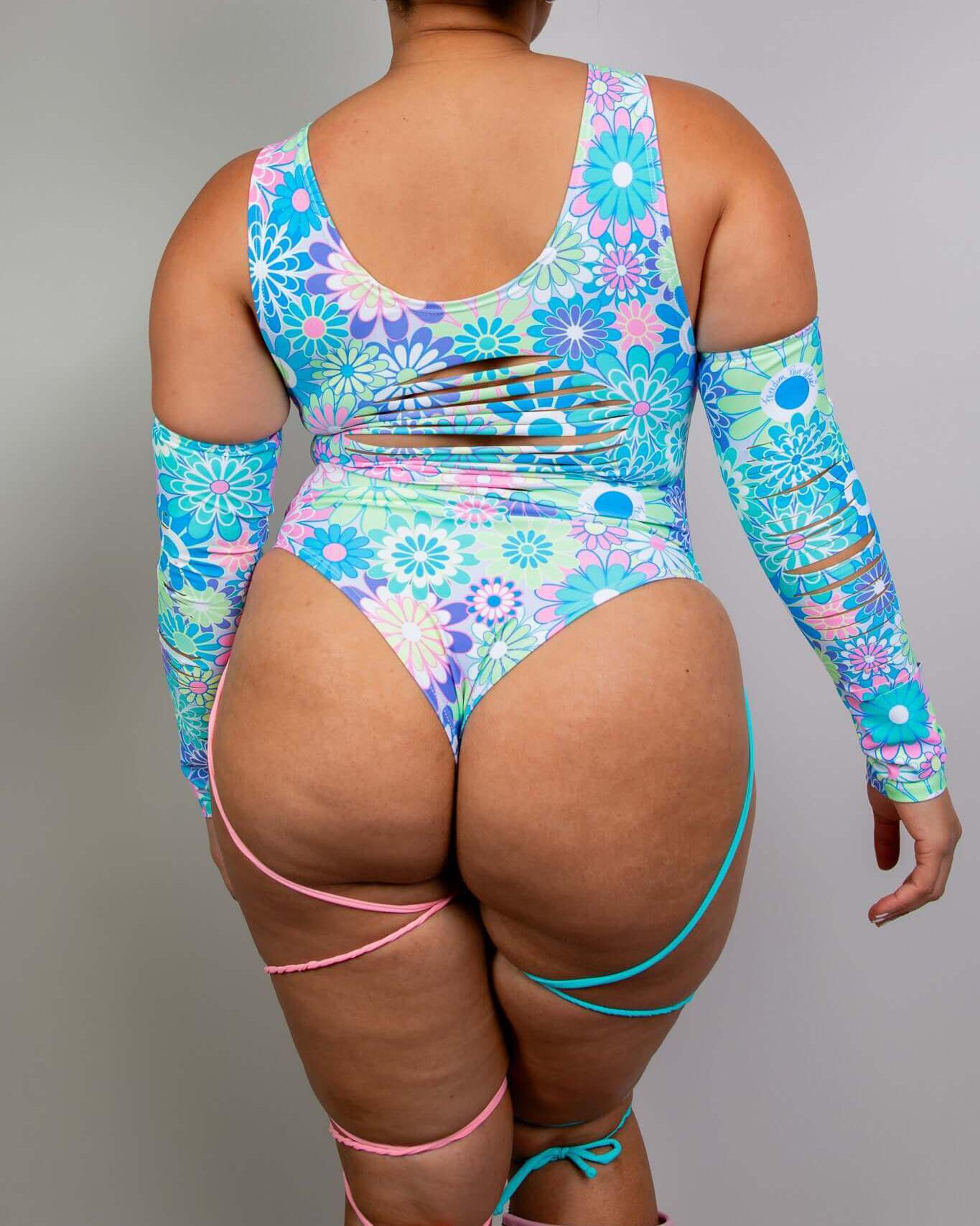 Retro Bloom bodysuit with pastel floral print, side slits, and leg straps, perfect for rave outfits.