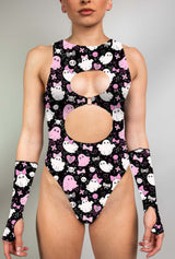 Model wearing keyhole bodysuit with pink and white spooky ghost print and matching gloves.