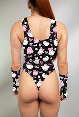 Model wearing keyhole bodysuit with pink and white spooky ghost print and matching gloves.