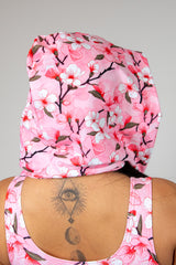 Sakura assassin hood with pink cherry blossom design worn, showcasing a stylish festival accessory for rave outfits.