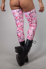 Sakura leg sleeves in pink cherry blossom design, paired with black platform boots, ideal for rave outfits and festivals.