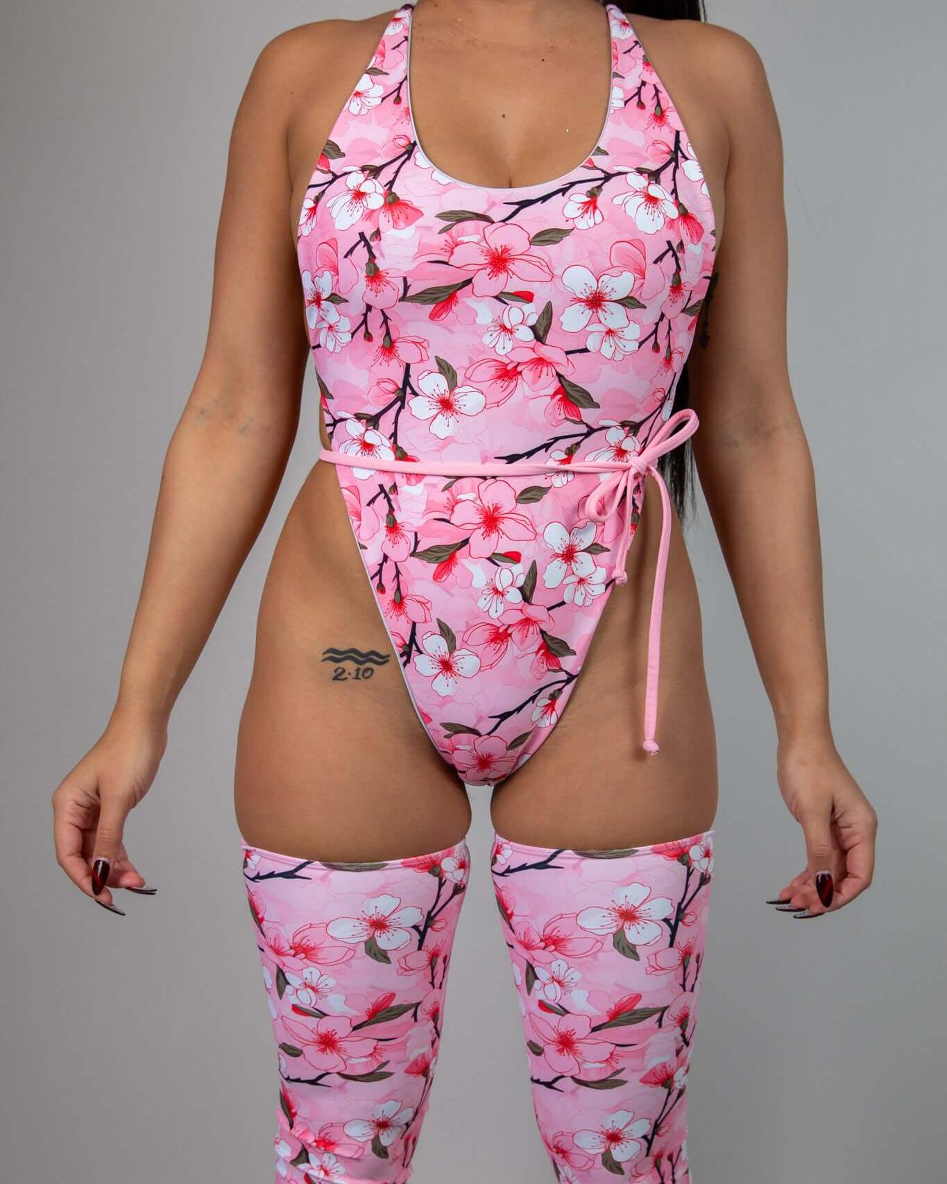 Sakura Temptation Cheeky One Piece in pink cherry blossom design, perfect for rave outfits and spring events.