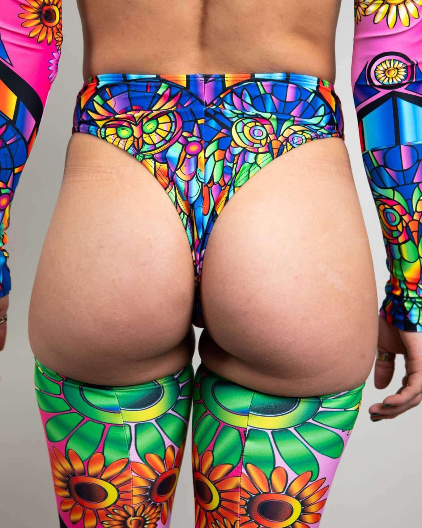 High-waisted neon thong and colorful arm sleeves, perfect for rave outfits and festival vibes.