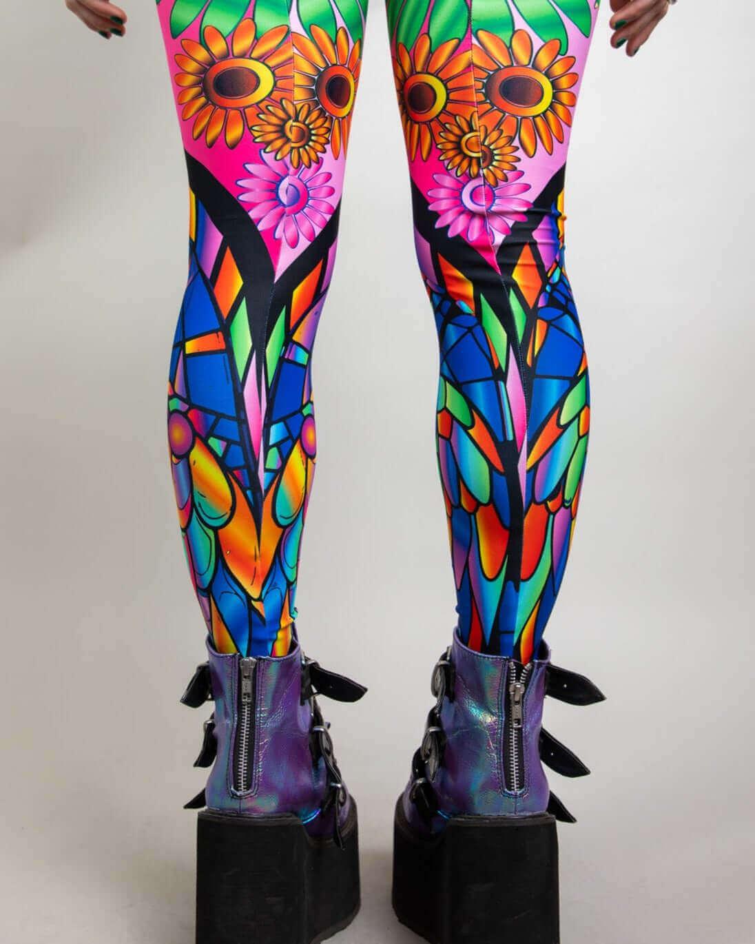 Vibrant psychedelic leg sleeves featuring neon owls, flowers, and peace signs, perfect for rave outfits.