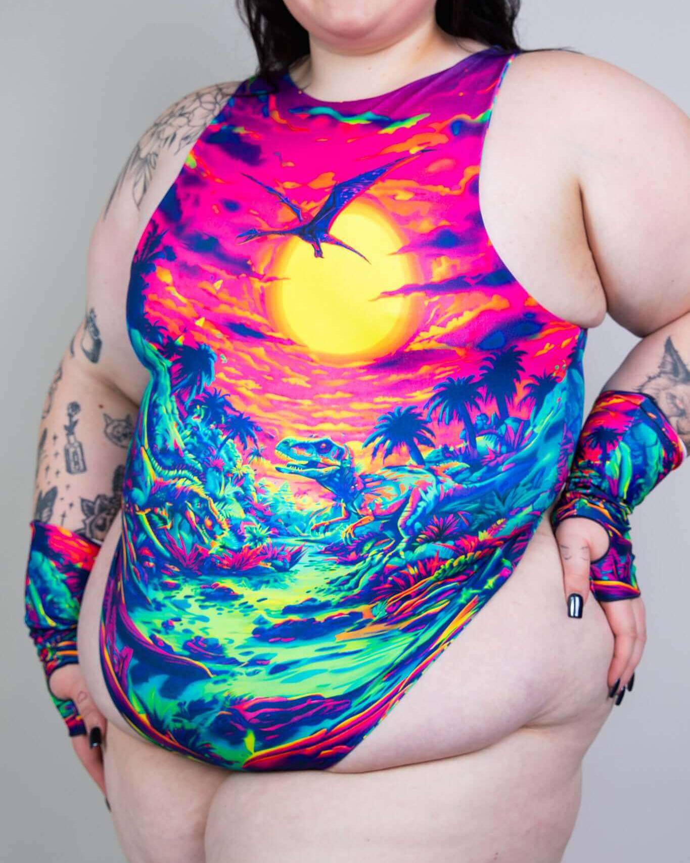 Model wearing colorful Saurian High Neck Bodysuit with vibrant dinosaur and sunset print, perfect for rave outfits.