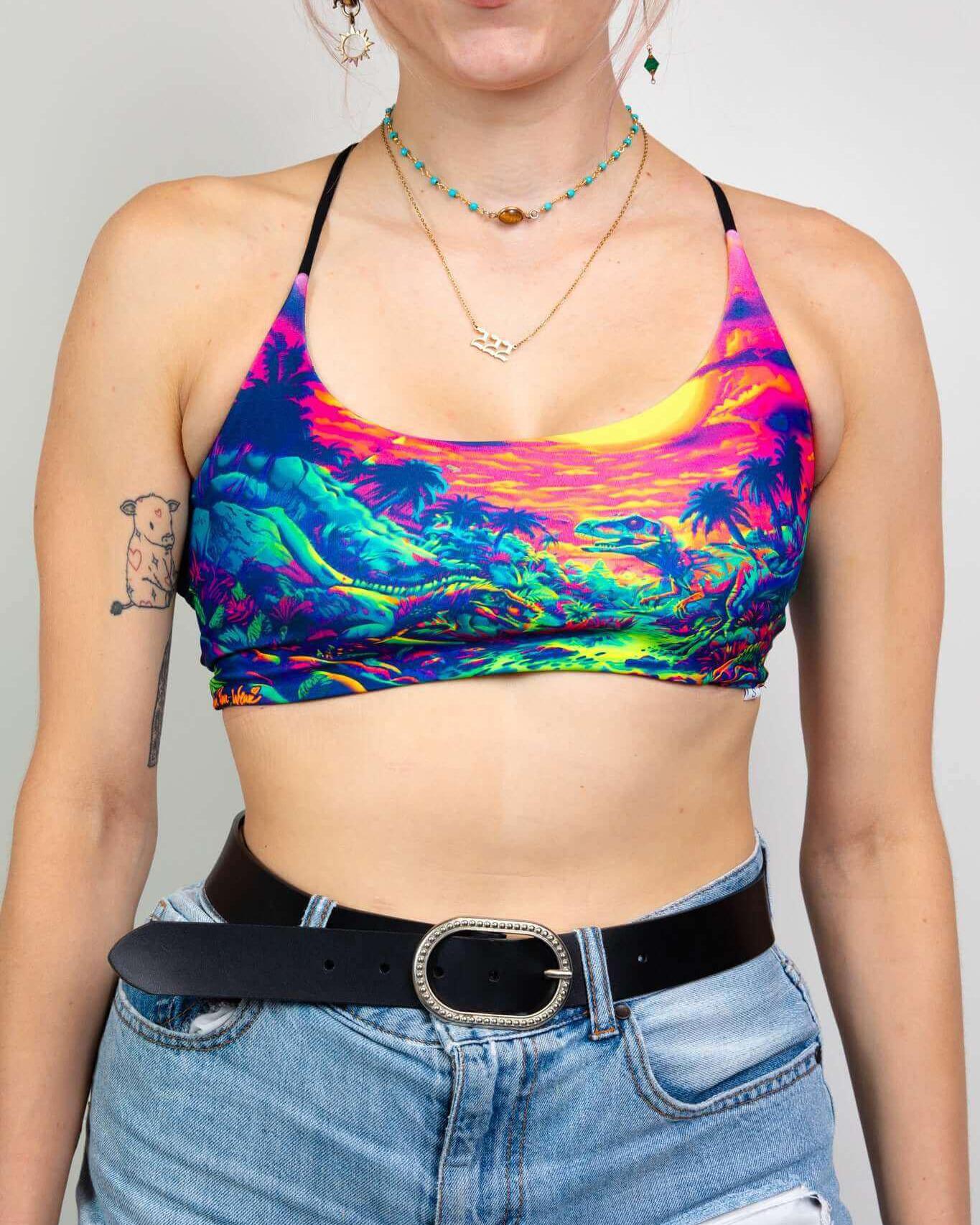 Model wearing a colorful crop top, perfect for rave outfits, featuring vibrant tropical design and adjustable straps.