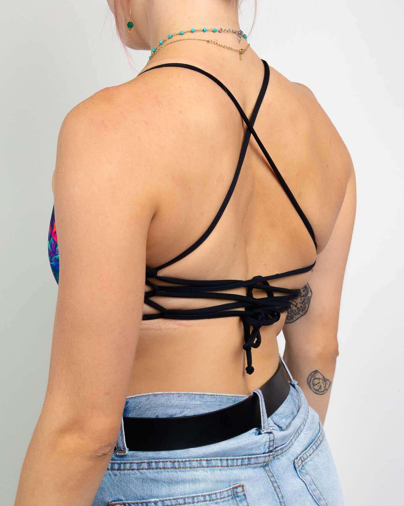 Model showcasing the back of the Saurian Reversible Lush Top with adjustable tie straps and a stylish design.