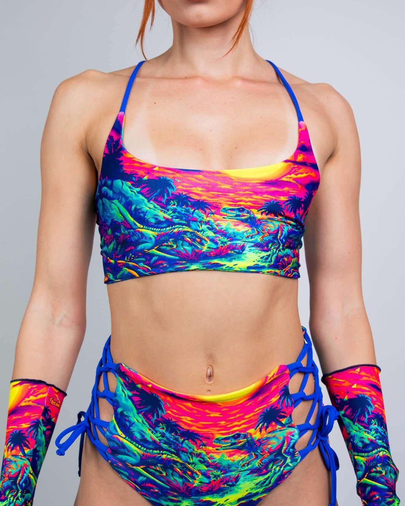 Model wearing a vibrant multicolor crop top and high-waisted bikini bottom, showcasing a bold summer rave outfit.