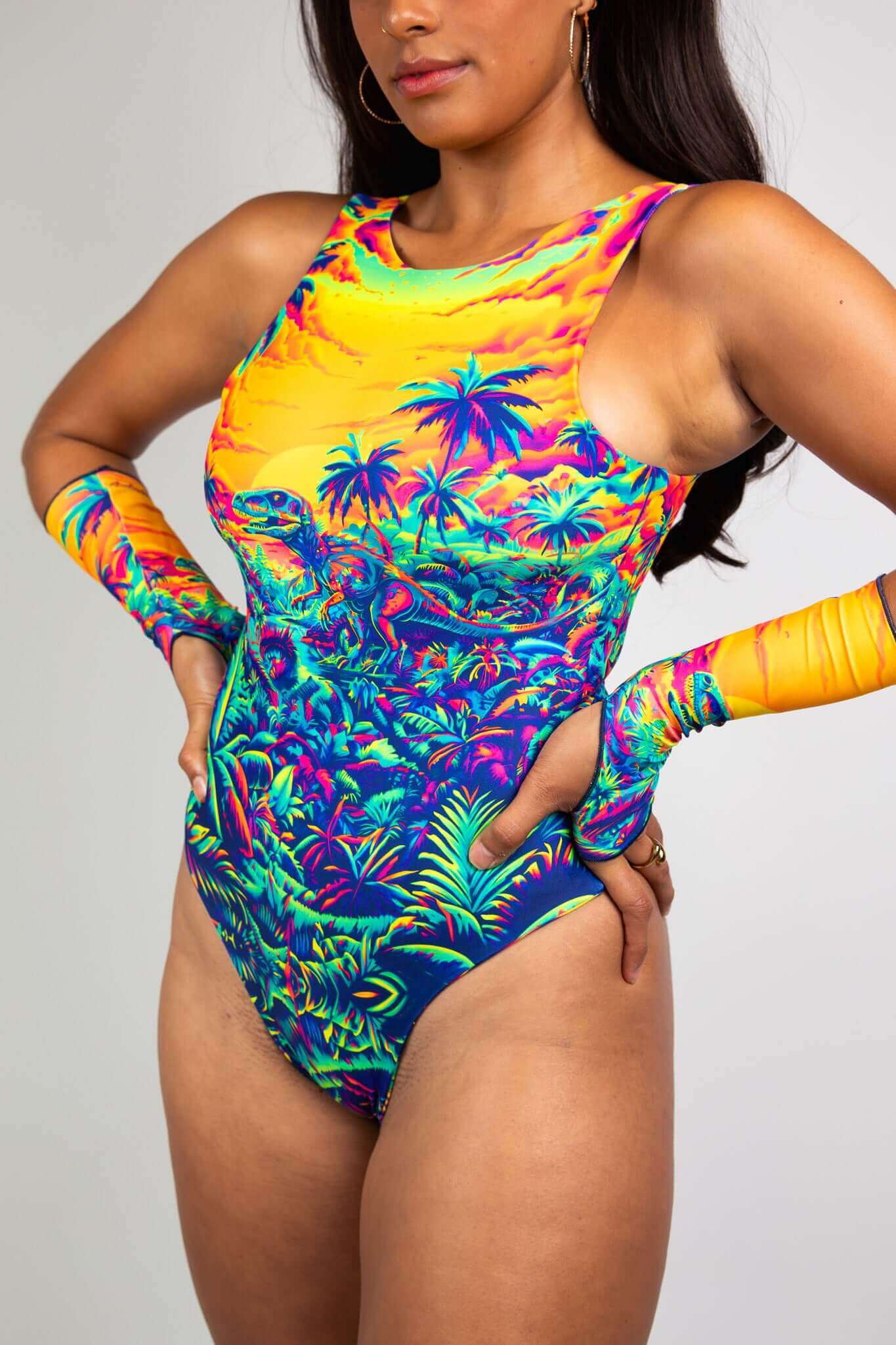 Freedom Rave Wear bodysuit with a vibrant sunset and dinosaur scene, complemented by matching arm sleeves, perfect for rave events.