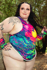 Freedom Rave Wear bodysuit in a plus-size design, featuring a vibrant tropical dinosaur print, perfect for festivals and rave events.