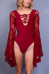 Model in Freedom Rave Wear's red goddess bodysuit with lace sleeves, designed for a captivating rave look.