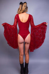 Rear view of a model in a red rave bodysuit with lace sleeves, paired with furry ears and boots, from Freedom Rave Wear.