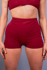Model sporting Freedom Rave Wear's high-waisted red rave shorts, designed for comfort and style.