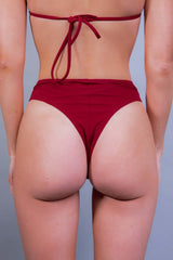Rear view of a red high-waisted rave bottom from Freedom Rave Wear, emphasizing a bold festival look