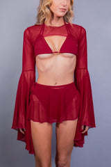 Model in Freedom Rave Wear's scarlet mesh top with bell sleeves and matching swirl skirt.
