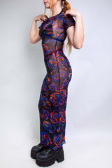 Side view of a model wearing a colorful mesh baby tee maxi dress, perfect for rave outfits.